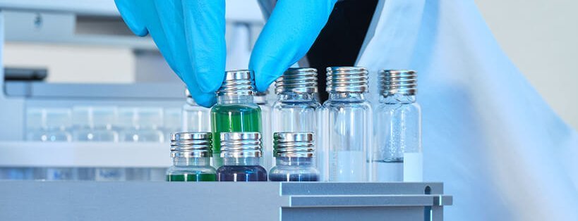 Scientist placing a PAL PFAS free vial into an autosampler tray for contamination-free analysis.