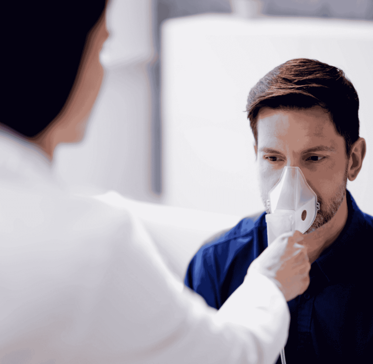 A patient breathing into an analysis device.