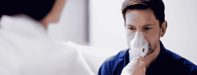 A patient breathing into an analysis device.