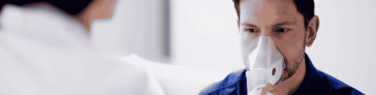 A patient breathing into an analysis device.