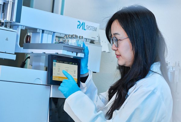 Scientist operating a touchscreen interface on a PAL System in a modern laboratory environment