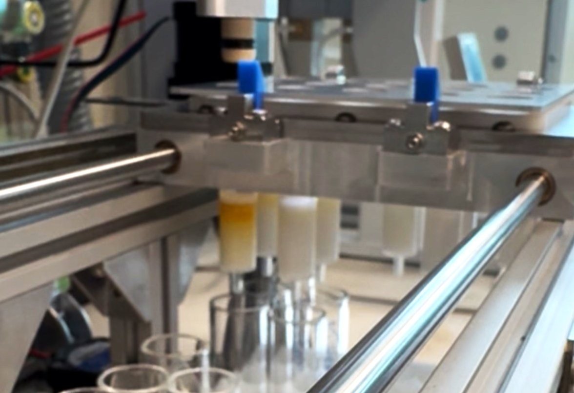 Close-up of an SPE Tiber system in operation, showing laboratory equipment and test tubes being processed.